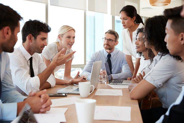 Business team chatting around a table.