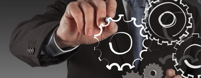 Best Practices for an Effective ERP Implementation Man drawing cogs.