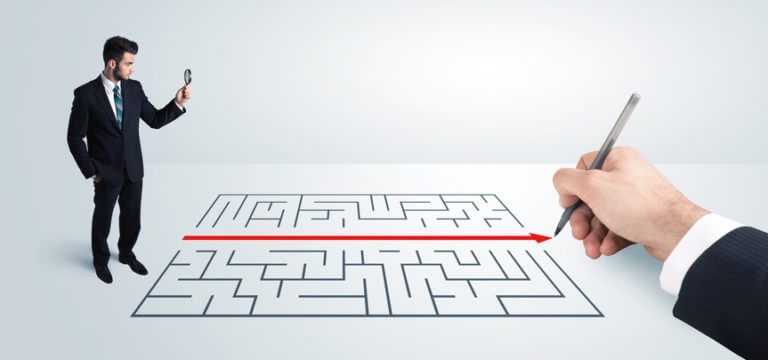 erp implementation risk Business man looking at the beset way through a drawn maze.