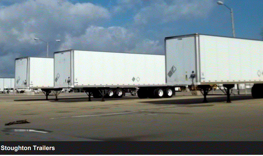 Tractor trailers parked in a parking lot.