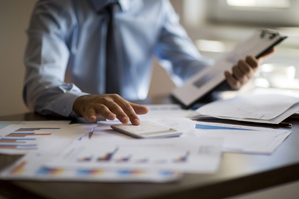 Business man using calculator