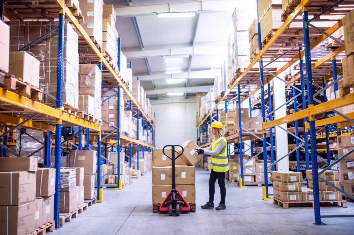 Female warehouse worker loading boxes.