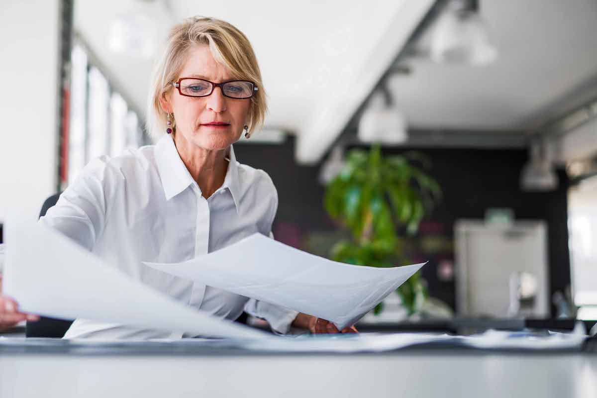 Woman in office reviewing papers