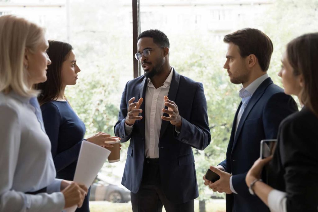 Men and women standing in a meeting