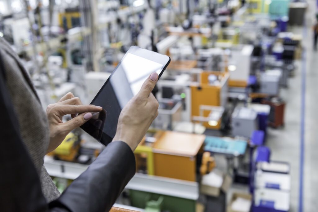 Female manager working on tablet in factory