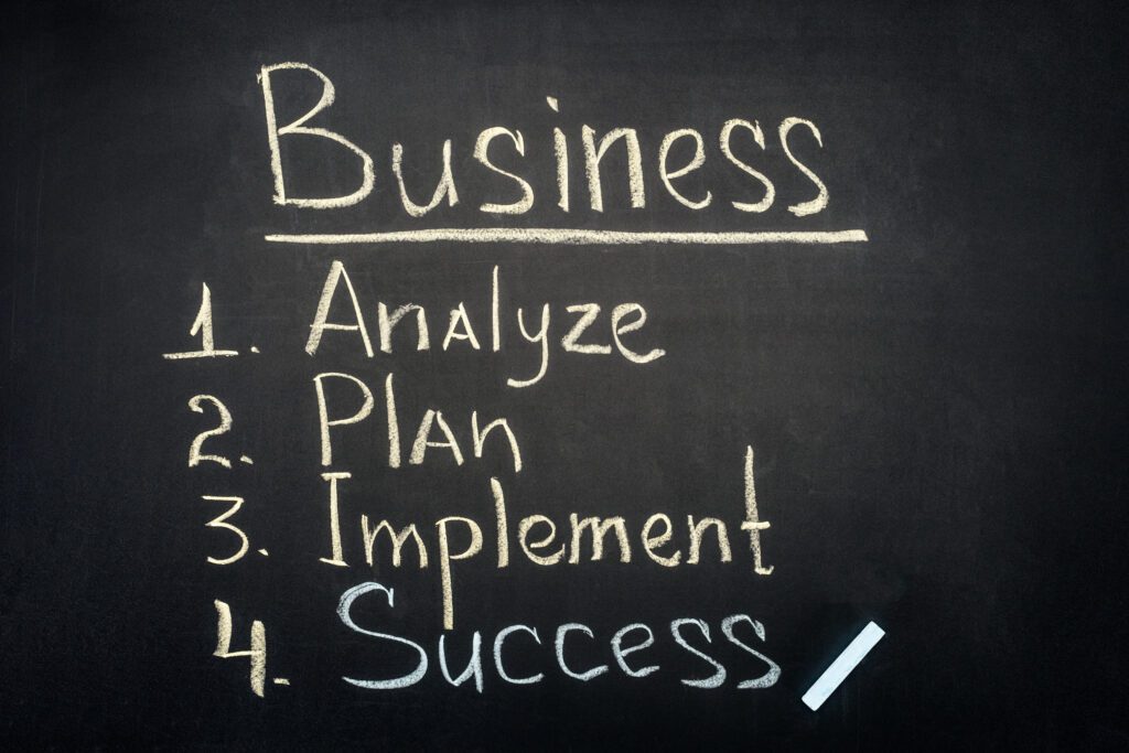 Business process management stages inscription on dark chalkboard