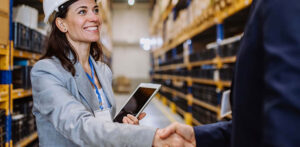 questions to ask an erp implementation partner consultant shaking hands in warehouse